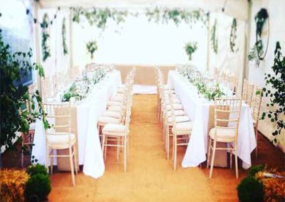 inside a party tent with two long tables
