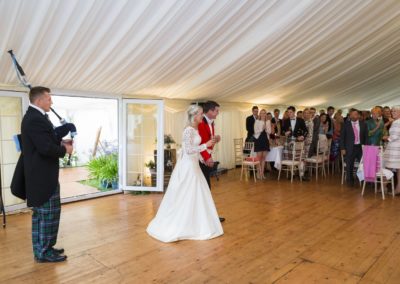 bride and groom arriving at the wedding marquee